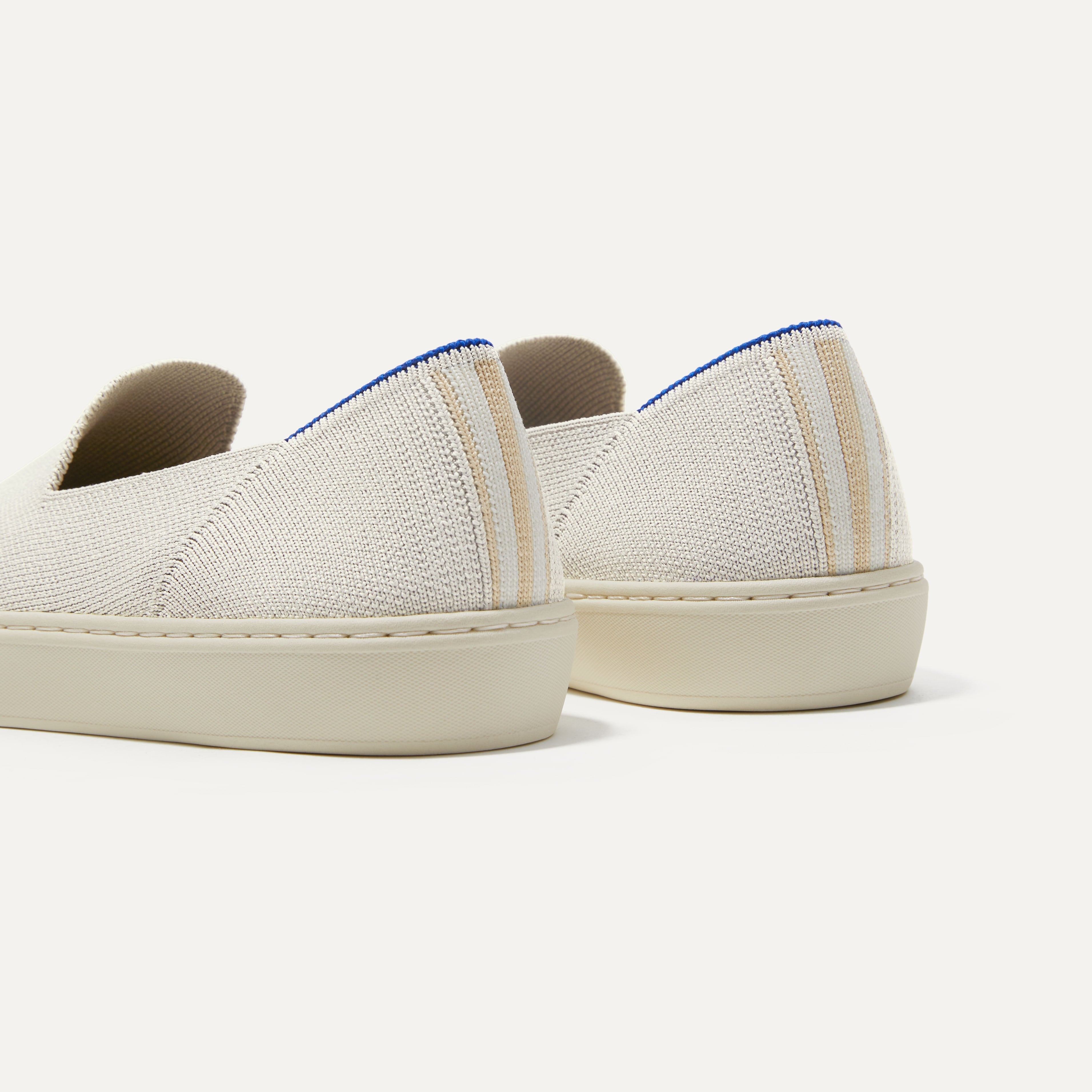 Close up of the heel of The Original Slip On Sneaker in Antique White, with Rothy's signature blue halo. 