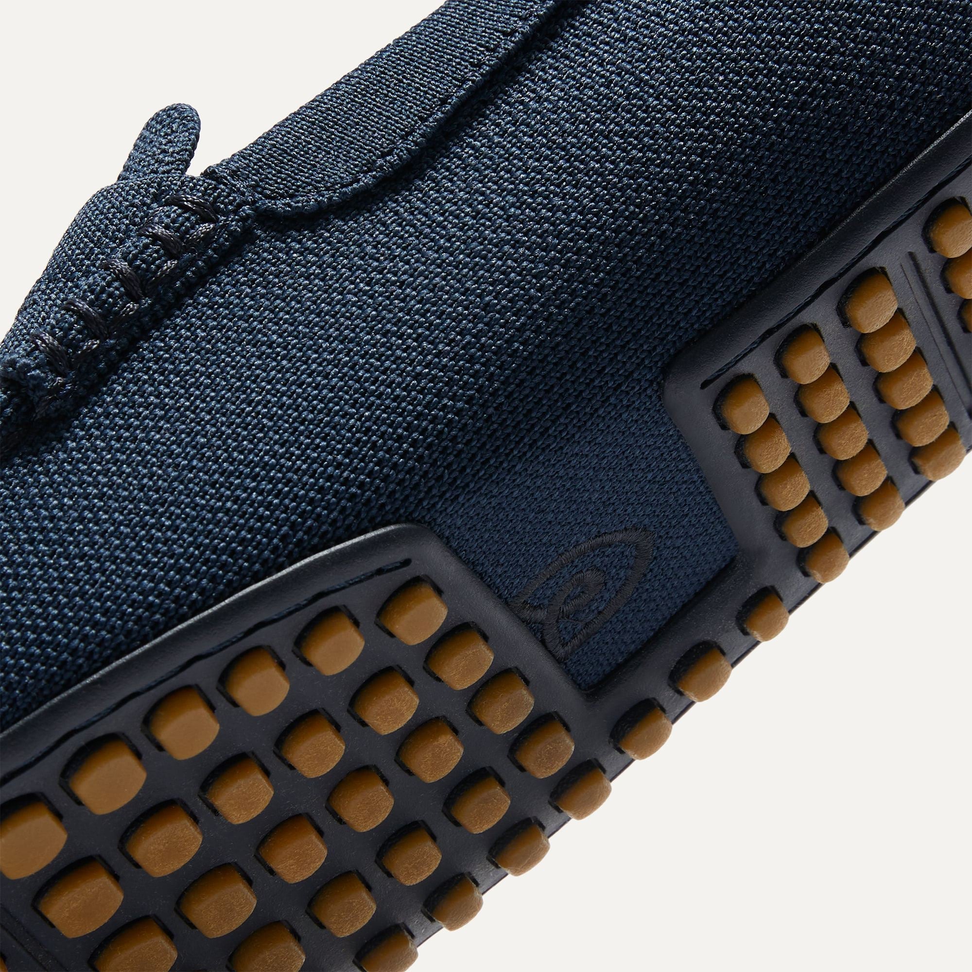 Close up of the outsoles of The Driving Loafer in Navy, with raised nub details and the Rothy's signet on the base of the shoe.