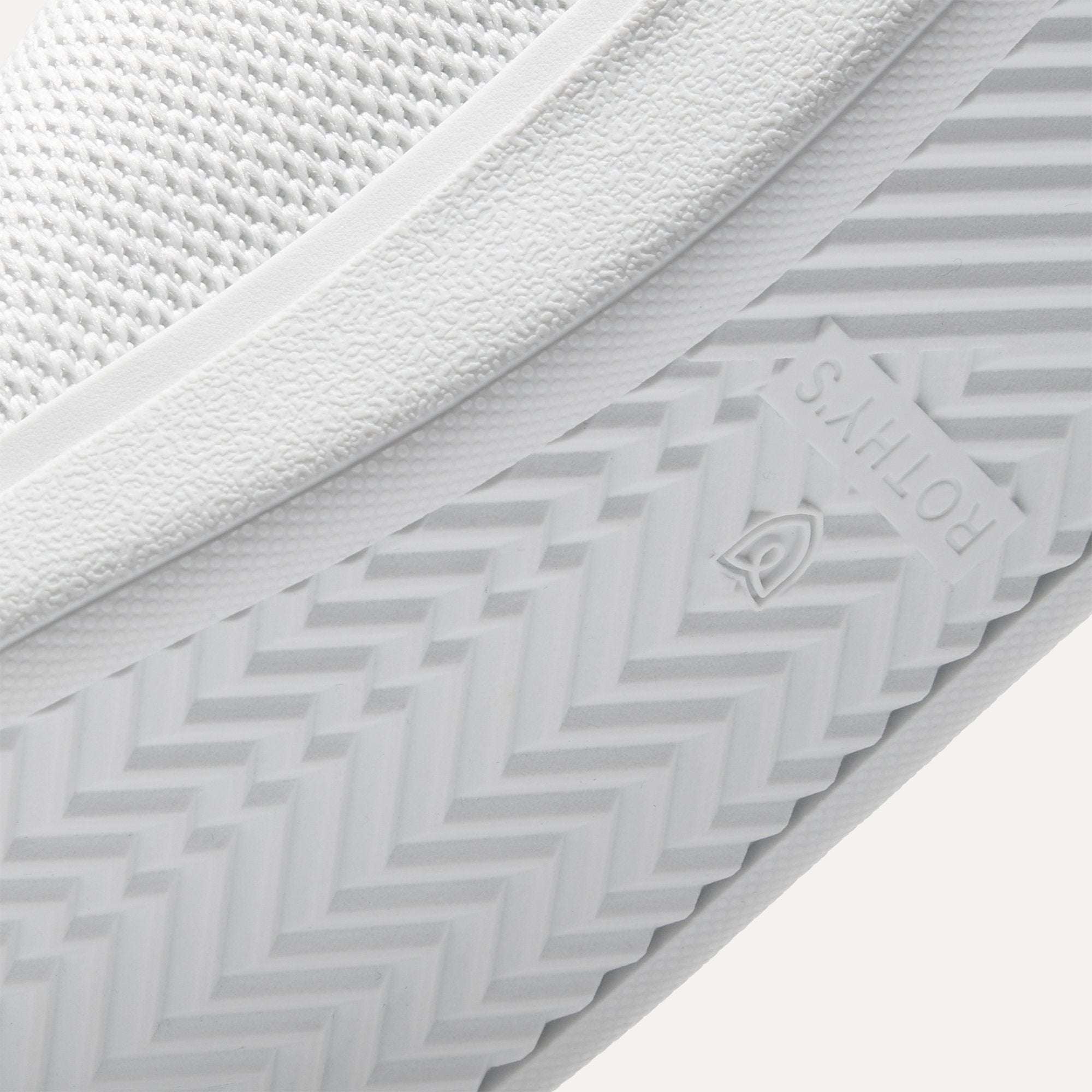 Close up of the outsoles of The RS01 Sneaker in White, with raised grooves for added traction.