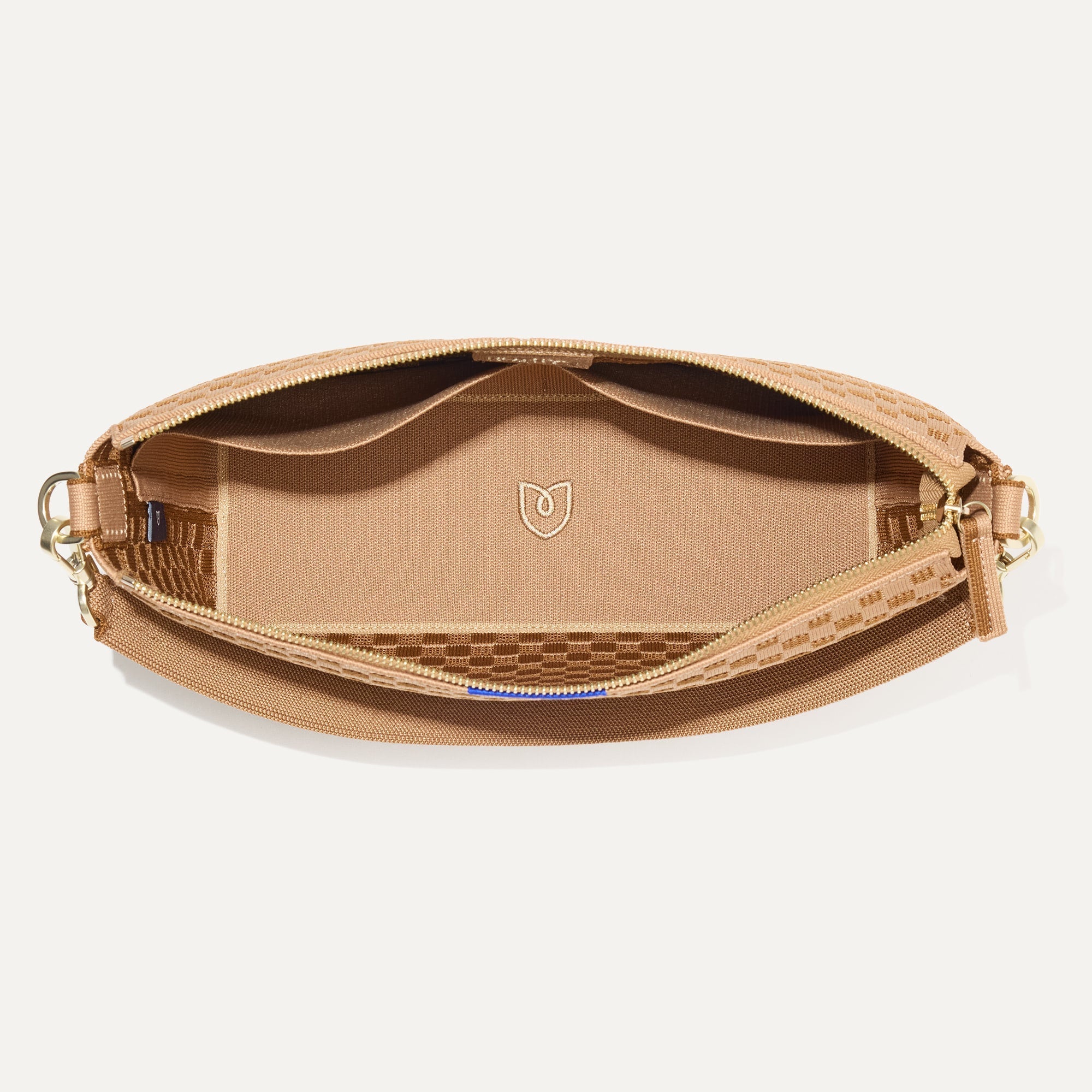 The Daily Crossbody Bag in Hazelnut shown from the top down, with zipper open and interior exposed.