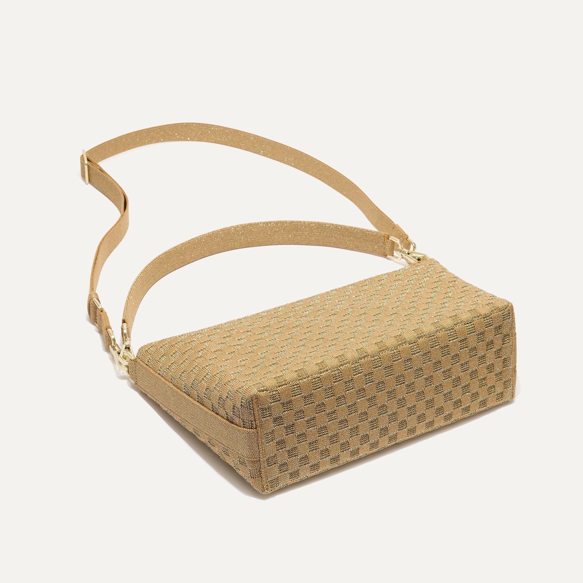 The Daily Crossbody in Golden Sun, lying flat, showing the detachable top handle and adjustable crossbody strap.