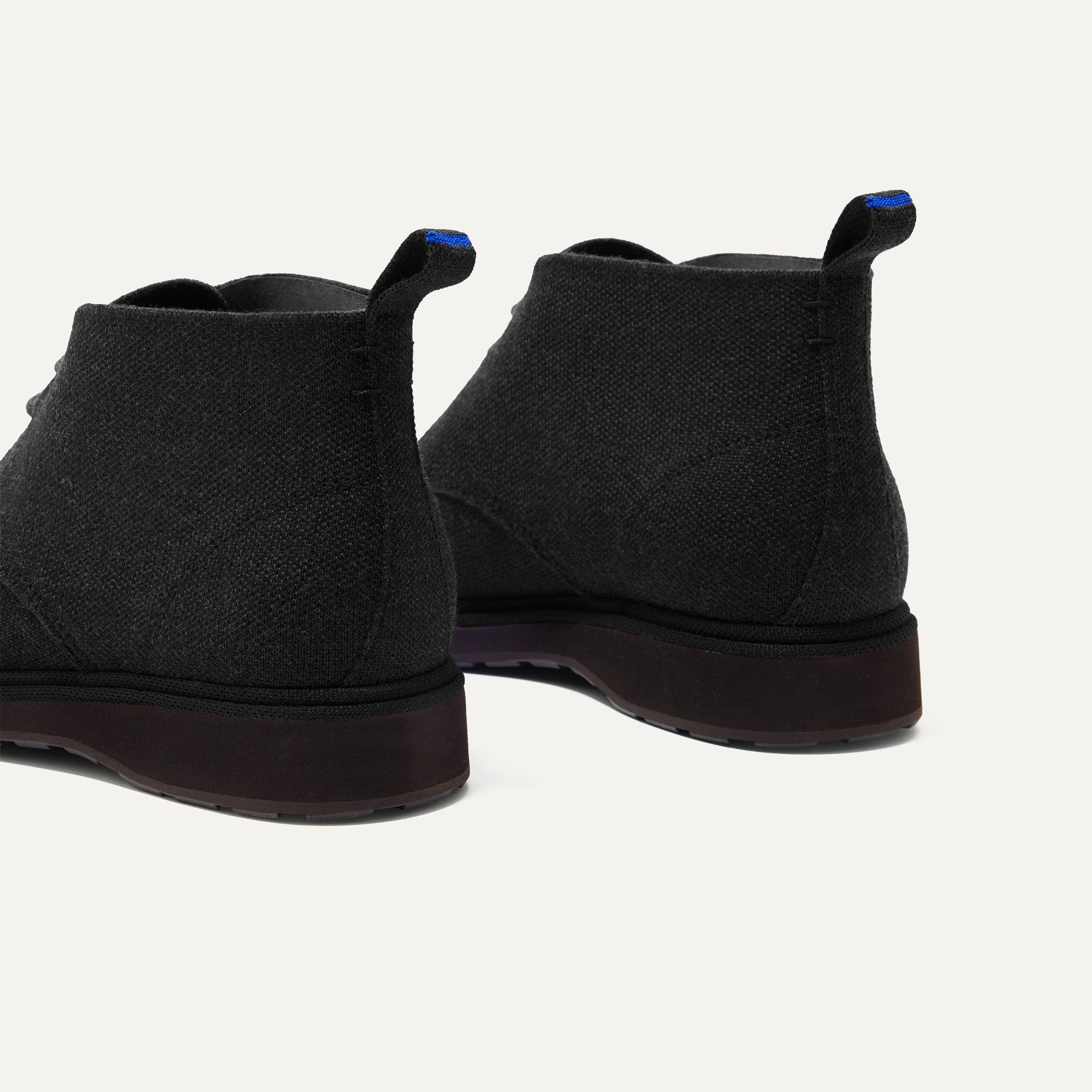 The Chukka Boot in Black shown from the back, in diagonal view. 