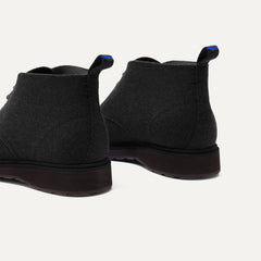 The Chukka Boot in Black shown from the back, in diagonal view. 