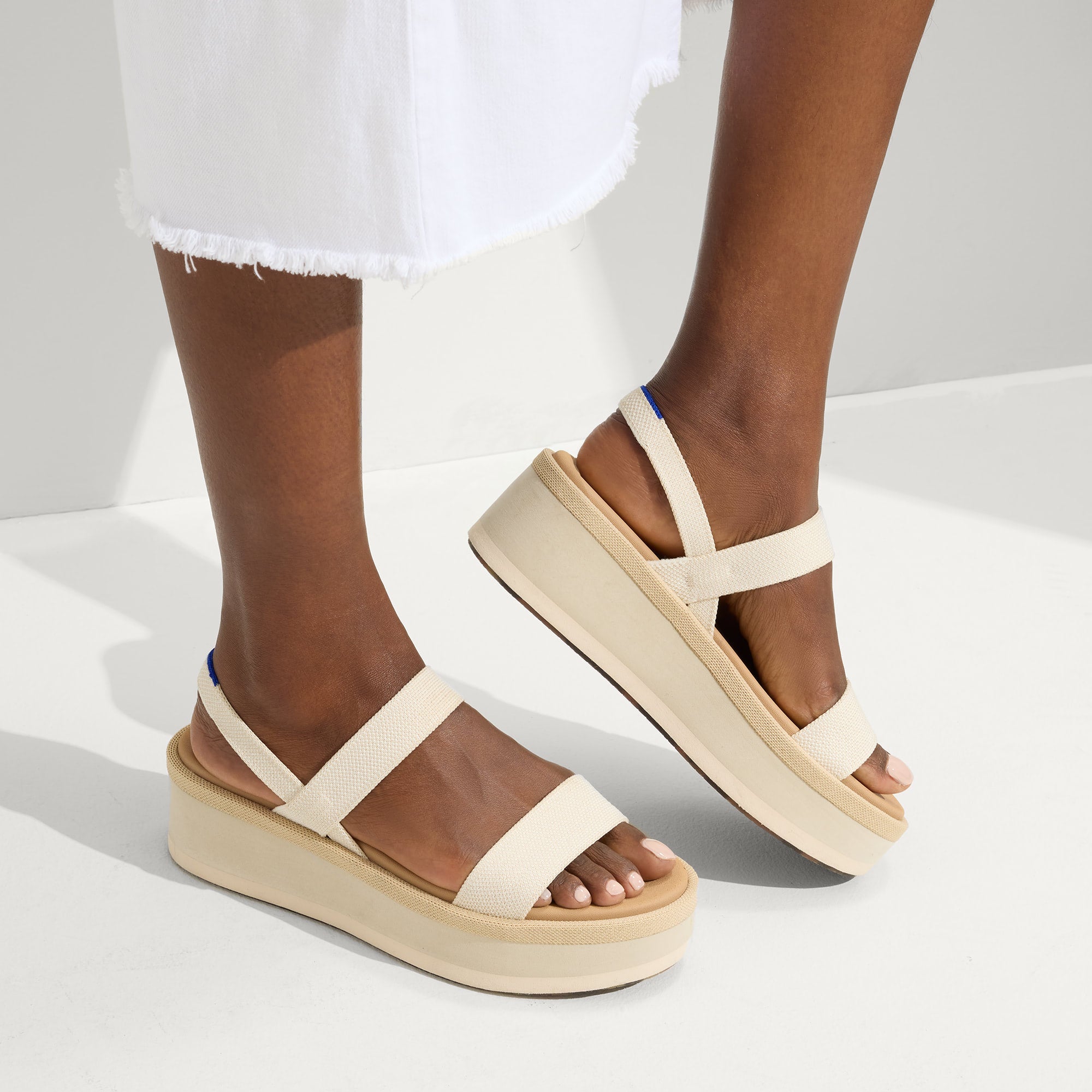 hover | Model wearing The Lightweight Wedge Sandal in Salt.