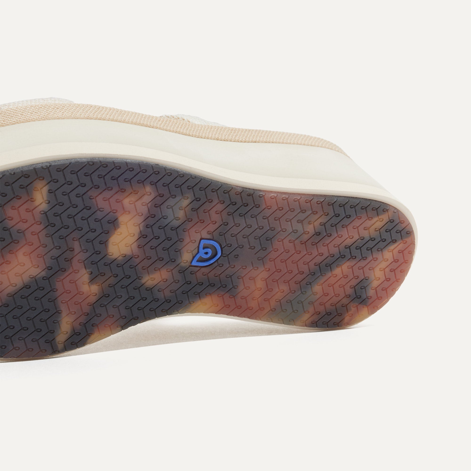 Close up of the outsole of The Lightweight Wedge Sandal in Salt, shown in a diagonal view. 