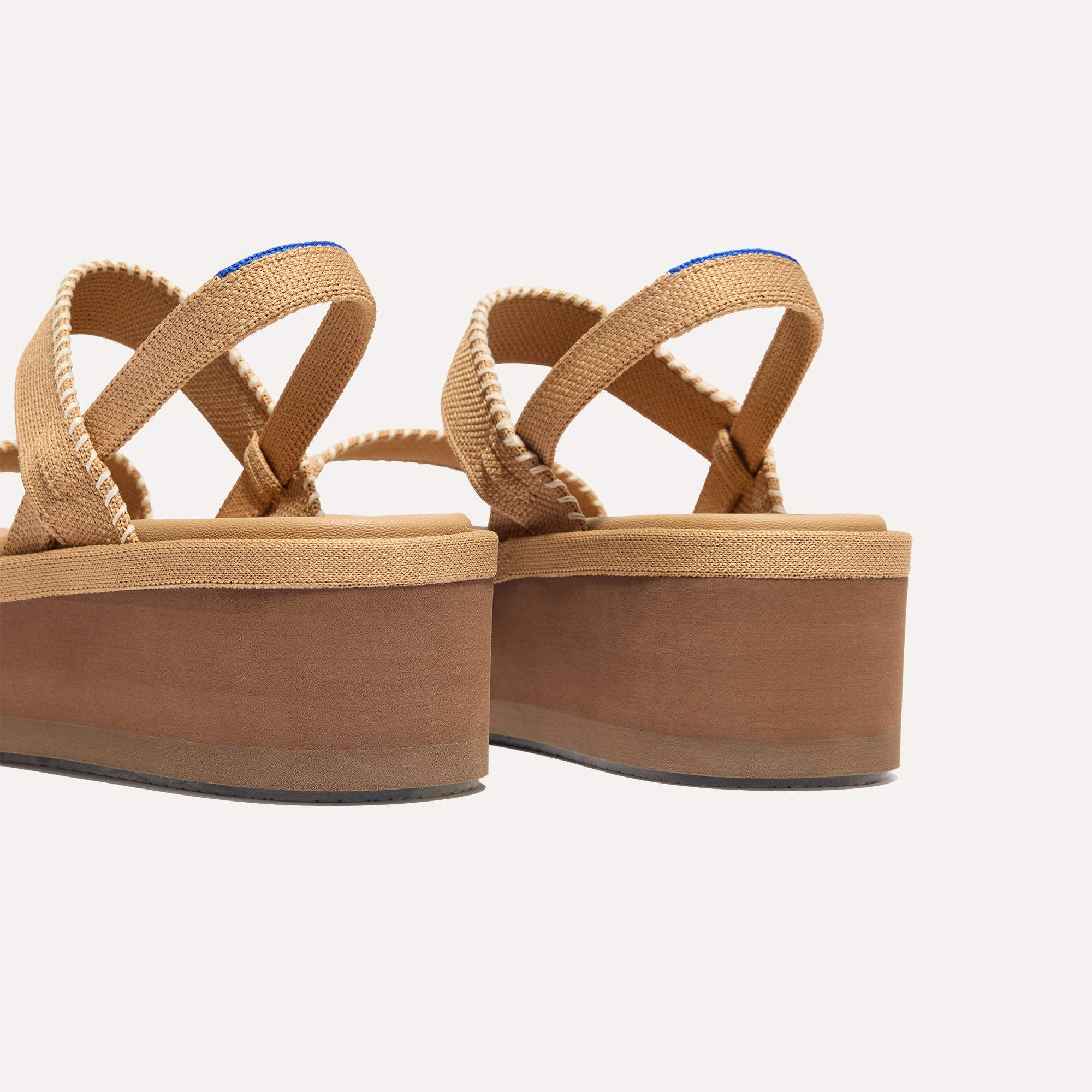 Close up of the heel of The Lightweight Wedge Sandal in Wren Whipstitch, with Rothy's signature blue halo.
