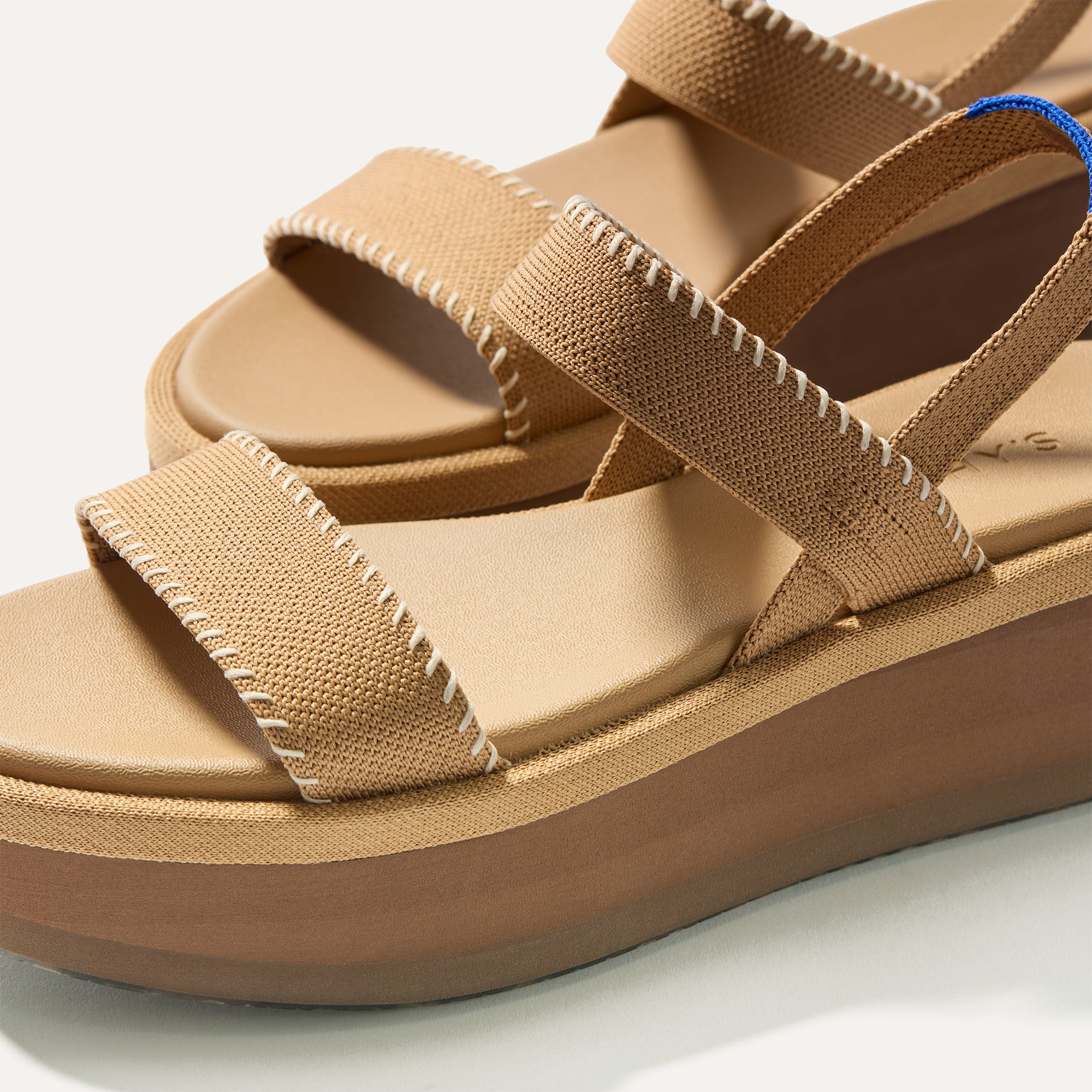 Close up of the toe strap of The Lightweight Wedge Sandal in Wren Whipstitch, in diagonal view. 