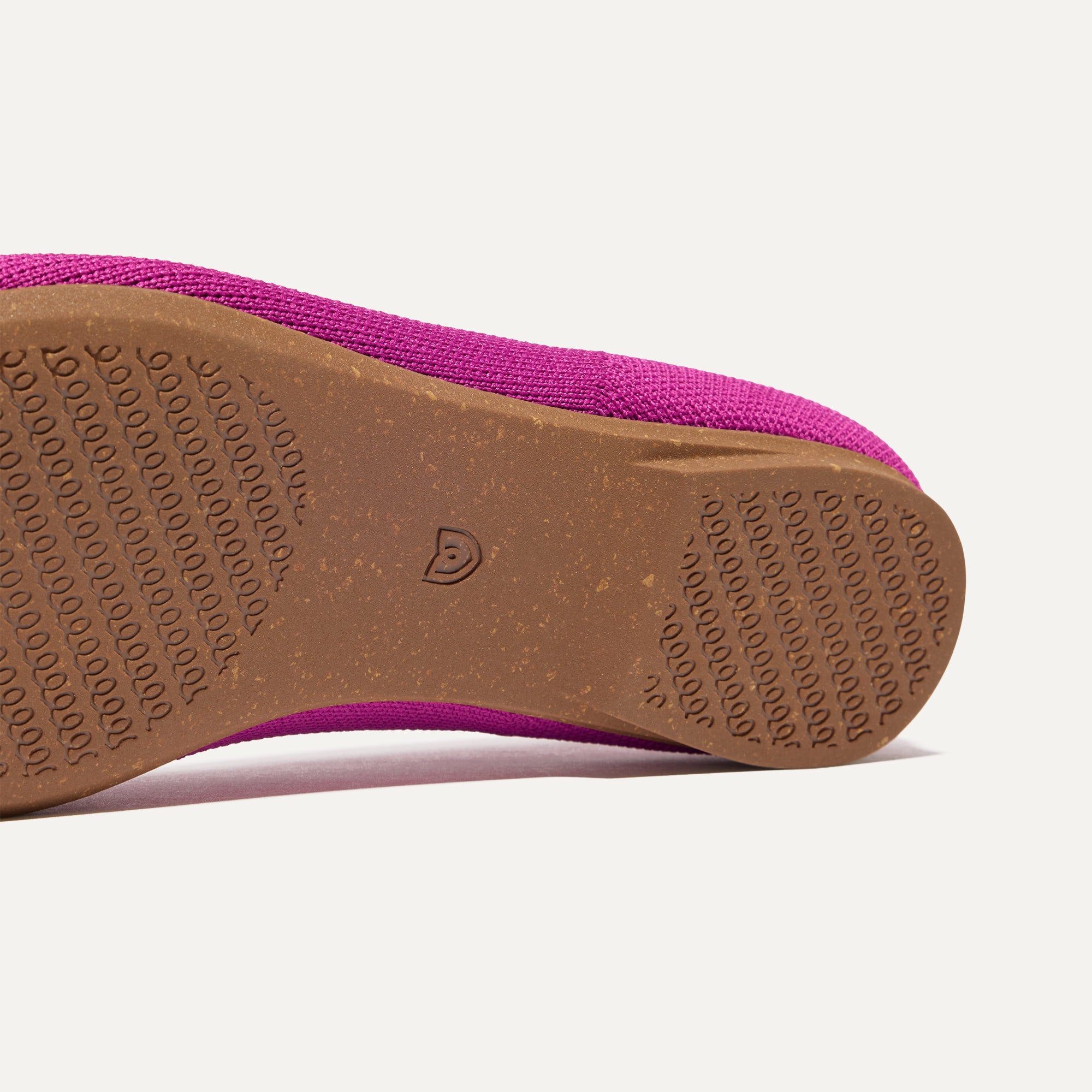 The sole of The Almond Tassel Loafer in Pink Bramble shown in diagonal view.