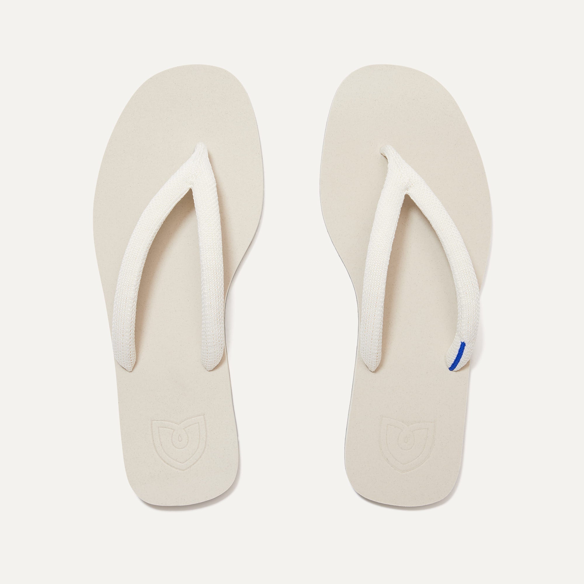 A pair of The Flip Flops in White Sand shown from the top view.