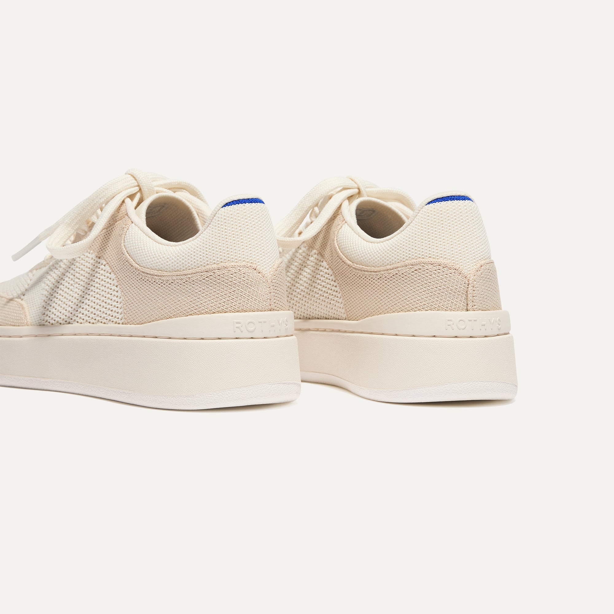Close up of the heel of The Court Sneaker in Sand Dune, with Rothy's signature blue halo. 