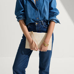 hover | Model shown holding The Wristlet in Ivory Perf.