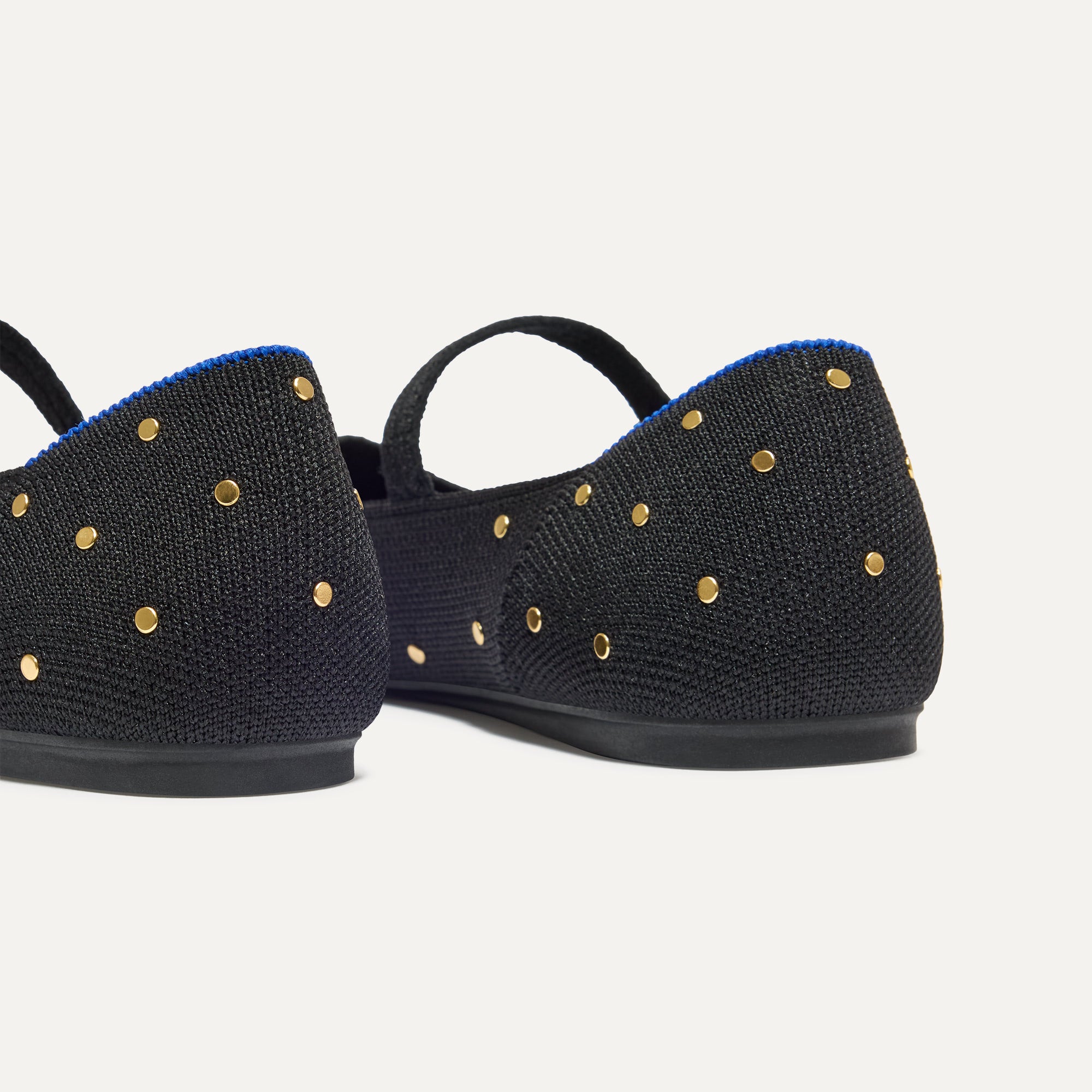 Close up of the heel of The Square Mary Jane in Studded Black, with Rothy's signature blue halo. 