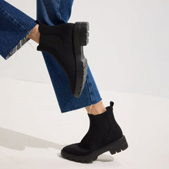 hover | Model wearing The Puddle Skipper Boot in Black.