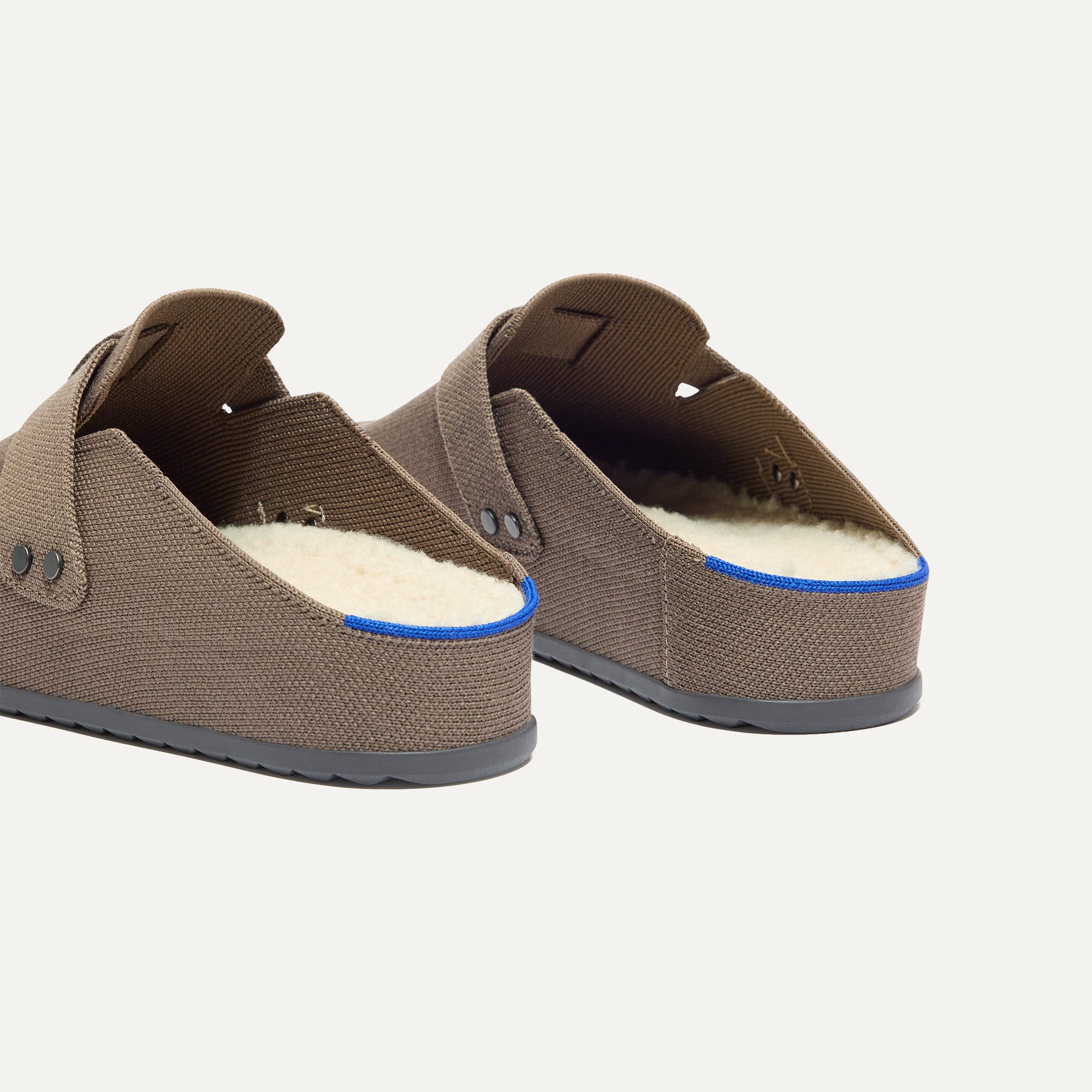 hover | Close up of the heel and sherpa lining of The Men's Cozy Clog in Sparrow, with Rothy's signature blue halo. 